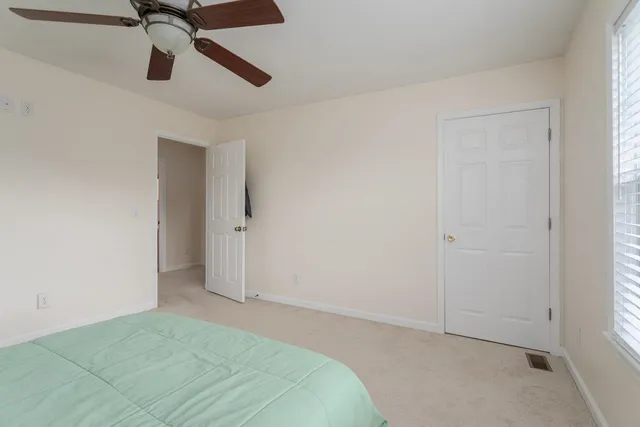 an empty room with chandelier fan