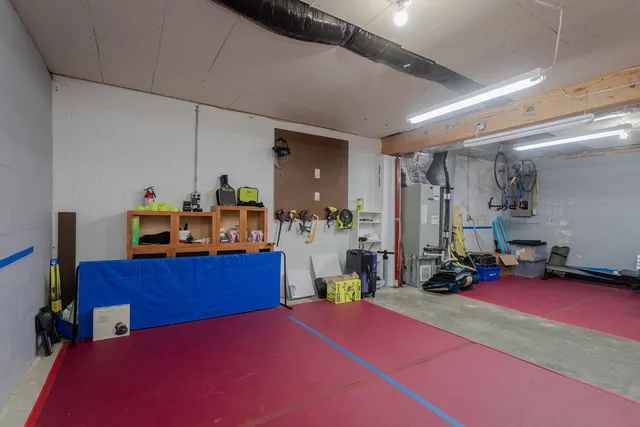 a room with gym equipment and a table