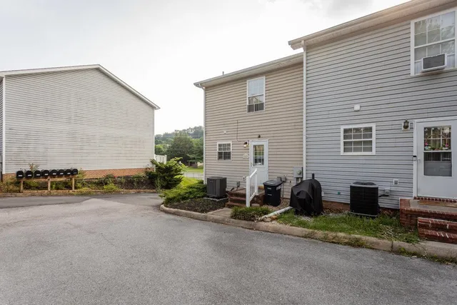 a backyard of a house with outdoor seating and a garage