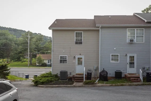 a brick house with a yard and plants