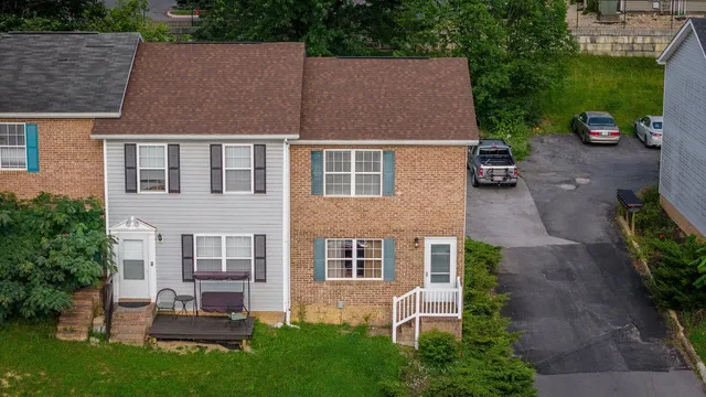 a aerial view of a house with garden and trees