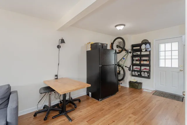 a view of a workspace with furniture and window
