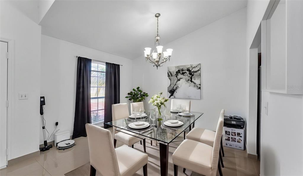587 Drayton Road Winter Haven, FL 33884 - Photo 11 of 40 a view of a dining room with furniture and chandelier