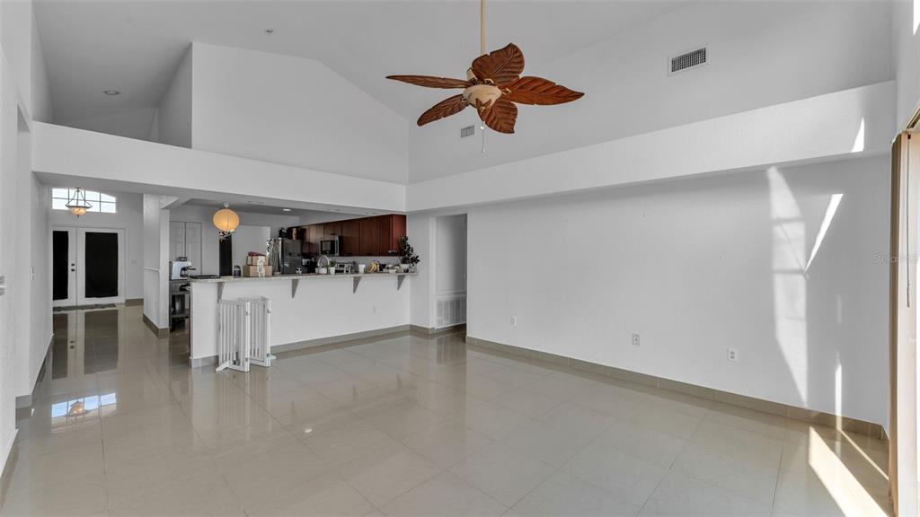 587 Drayton Road Winter Haven, FL 33884 - Photo 16 of 40 a view of a livingroom with furniture a ceiling fan and window