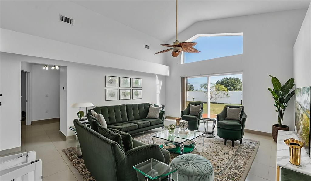 587 Drayton Road Winter Haven, FL 33884 - Photo 17 of 40 a living room with furniture potted plant and a flat screen tv