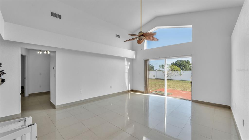 587 Drayton Road Winter Haven, FL 33884 - Photo 18 of 40 wooden floor in an empty room with a window