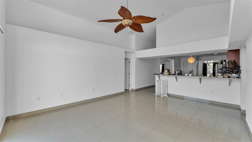 587 Drayton Road Winter Haven, FL 33884 - Photo 20 of 40 a view of kitchen and living room with ceiling fan