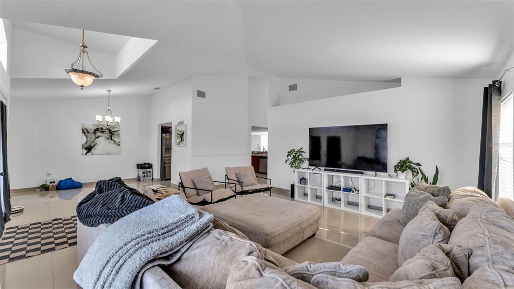 587 Drayton Road Winter Haven, FL 33884 - Photo 7 of 40 a bedroom with furniture and a flat screen tv