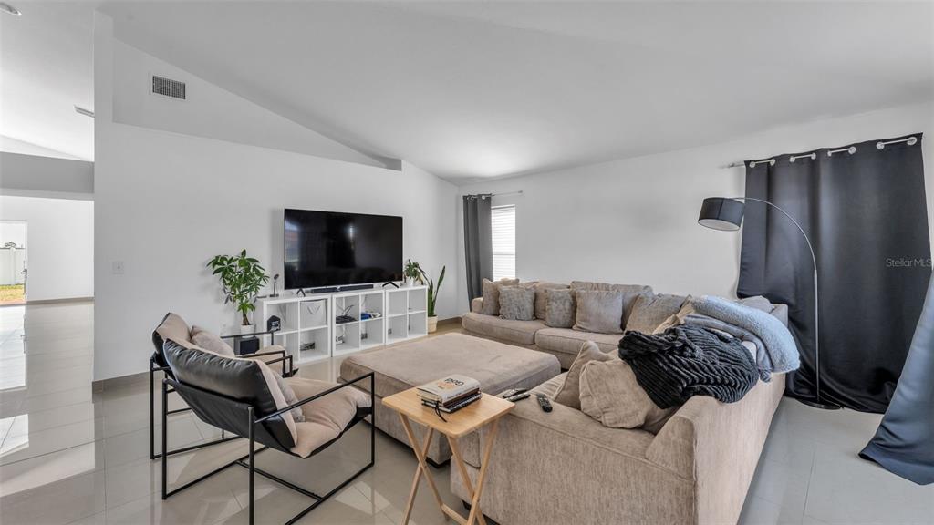 587 Drayton Road Winter Haven, FL 33884 - Photo 8 of 40 a living room with furniture and a flat screen tv