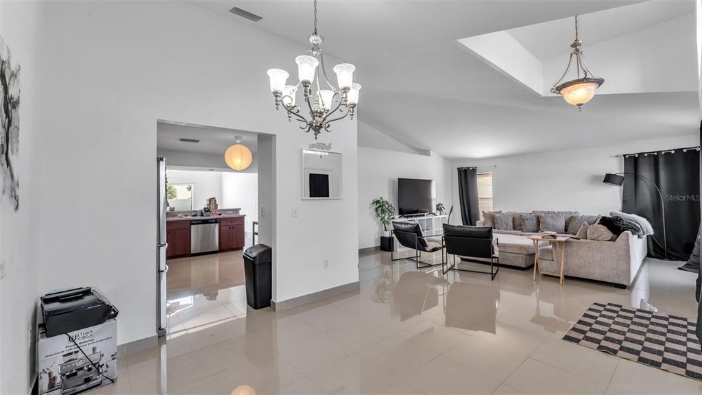 587 Drayton Road Winter Haven, FL 33884 - Photo 10 of 40 a living room with furniture a chandelier and a chandelier