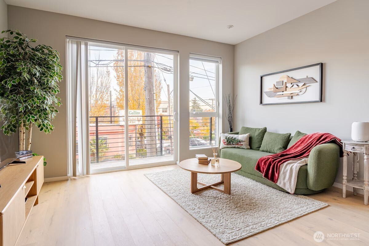 1709 20th Avenue, Unit A Seattle, WA 98122 - Photo 8 of 20 a living room with furniture and a large window with outer view