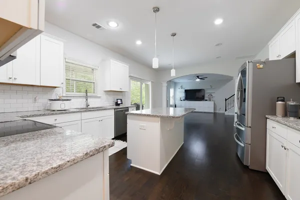 a kitchen with cabinets and stainless steel appliances