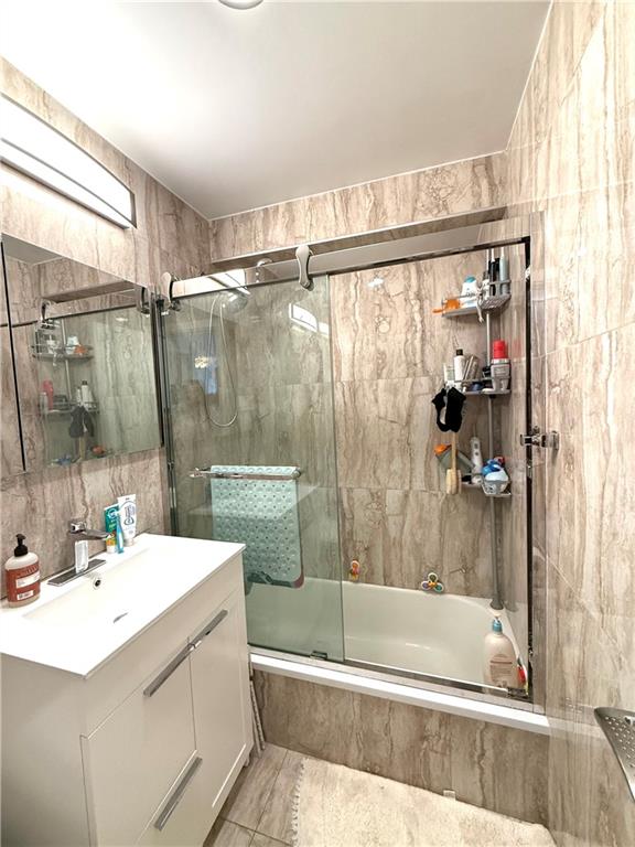 501 Surf Avenue, Unit 23M Brooklyn, NY 11224 - Photo 13 of 24 a bathroom with a sink mirror toilet and bathtub