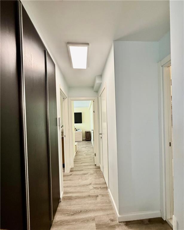 501 Surf Avenue, Unit 23M Brooklyn, NY 11224 - Photo 16 of 24 a view of a hallway with wooden floor and staircase