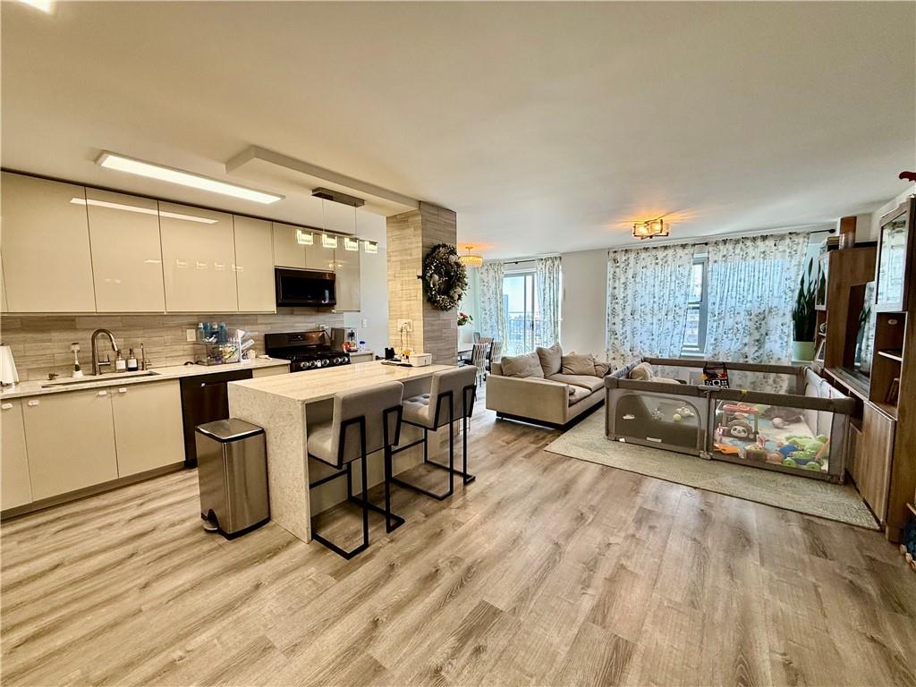 501 Surf Avenue, Unit 23M Brooklyn, NY 11224 - Photo 4 of 24 a kitchen with a sink appliances and cabinets