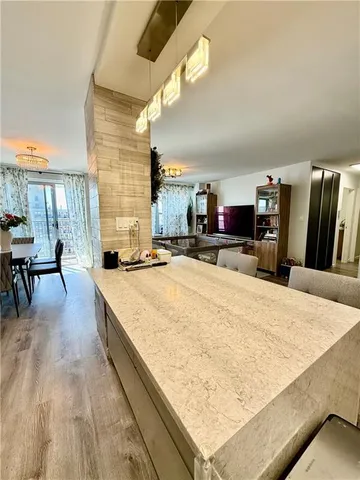 a living room with stainless steel appliances kitchen island granite countertop furniture and a kitchen view