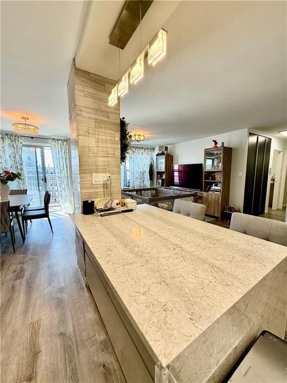 501 Surf Avenue, Unit 23M Brooklyn, NY 11224 - Photo 5 of 24 a living room with stainless steel appliances kitchen island granite countertop furniture and a kitchen view