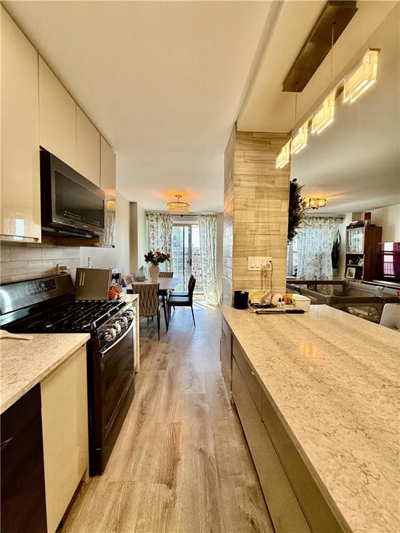 501 Surf Avenue, Unit 23M Brooklyn, NY 11224 - Photo 7 of 24 a large kitchen with a stove and cabinets