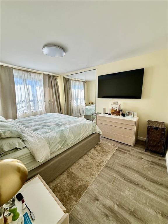 501 Surf Avenue, Unit 23M Brooklyn, NY 11224 - Photo 9 of 24 a bedroom with a bed and a flat screen tv