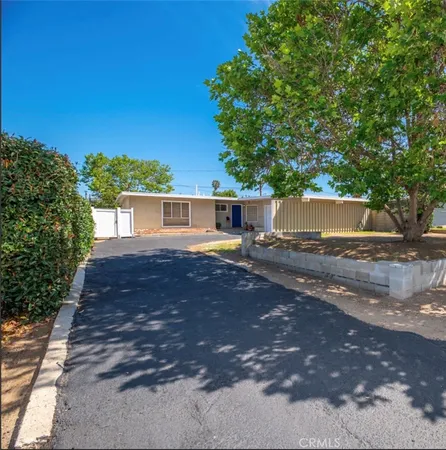 a view of a house with a backyard and garage