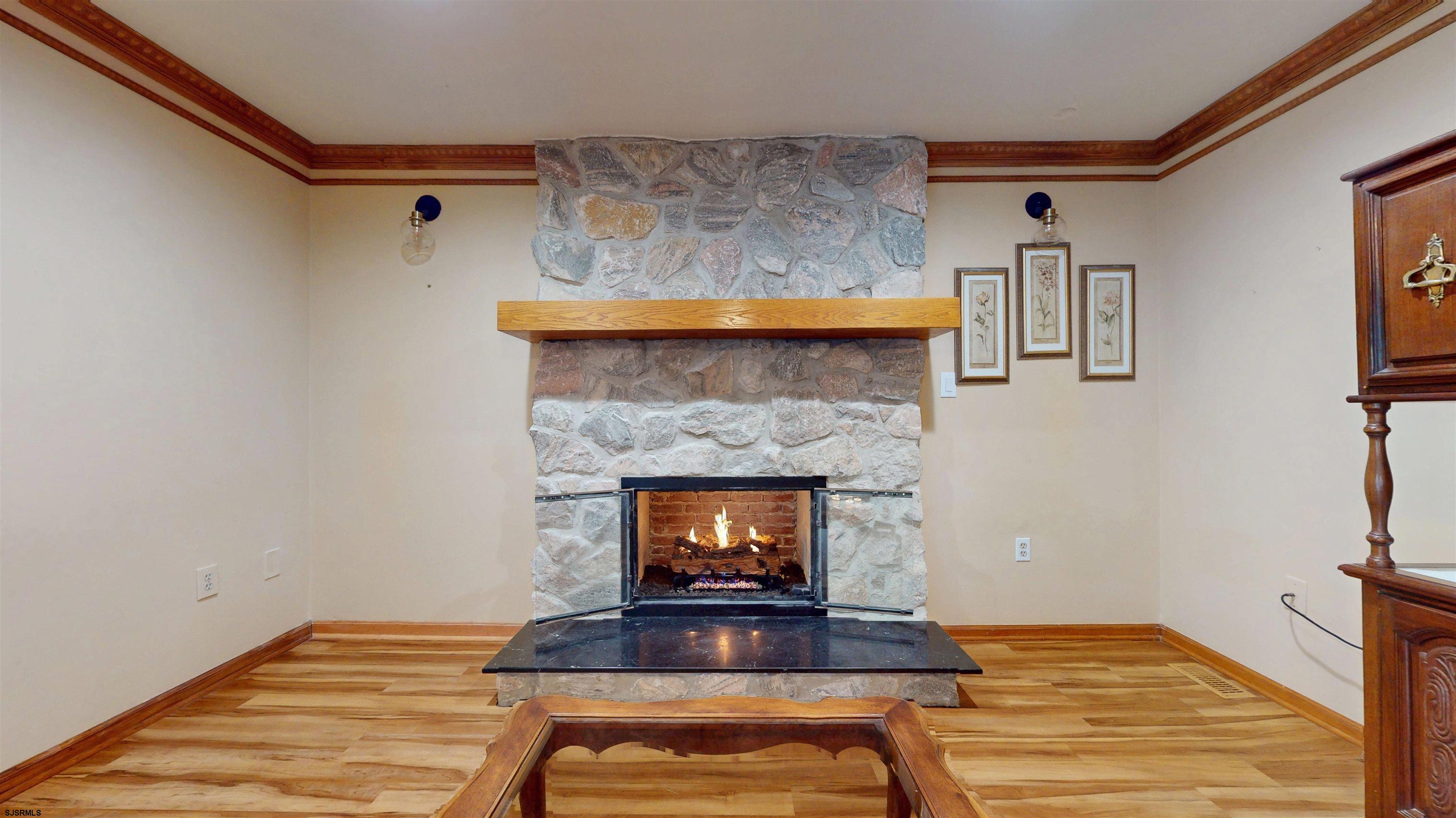 46 Victoria Lane Ocean View, NJ 08230 - Photo 11 of 66 a living room with a fireplace and a fireplace
