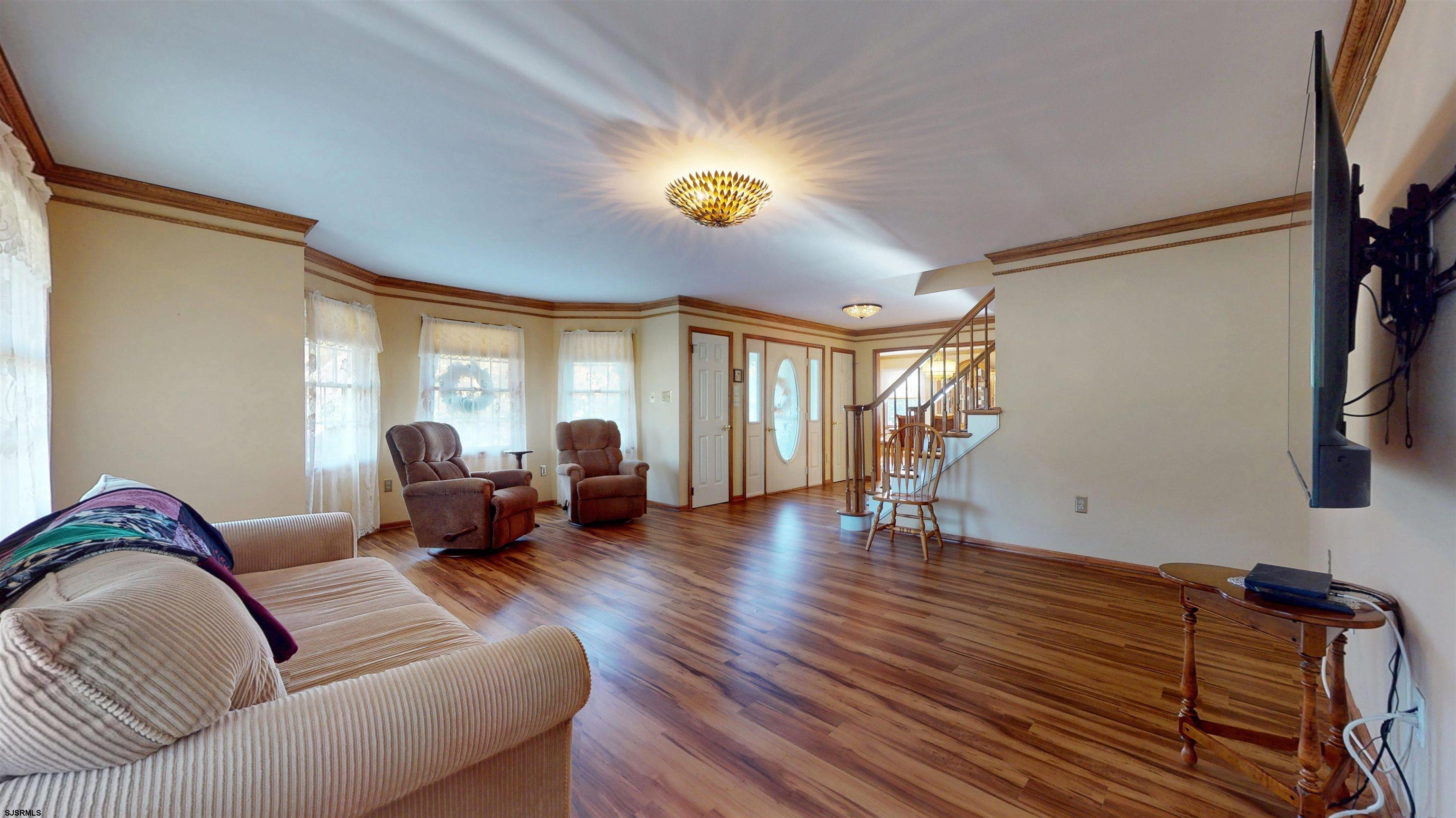 46 Victoria Lane Ocean View, NJ 08230 - Photo 13 of 66 a living room with furniture and a chandelier