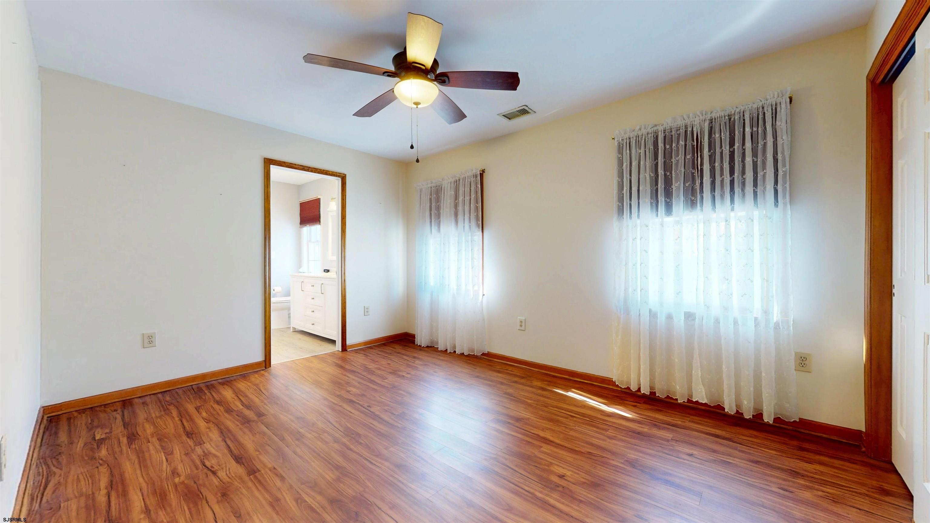 46 Victoria Lane Ocean View, NJ 08230 - Photo 23 of 66 an empty room with wooden floor and windows