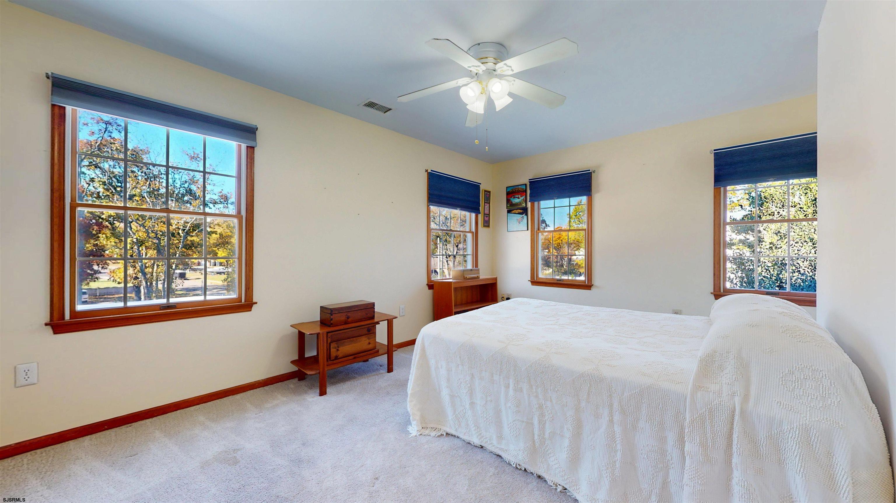 46 Victoria Lane Ocean View, NJ 08230 - Photo 24 of 66 a bedroom with a large bed and a window