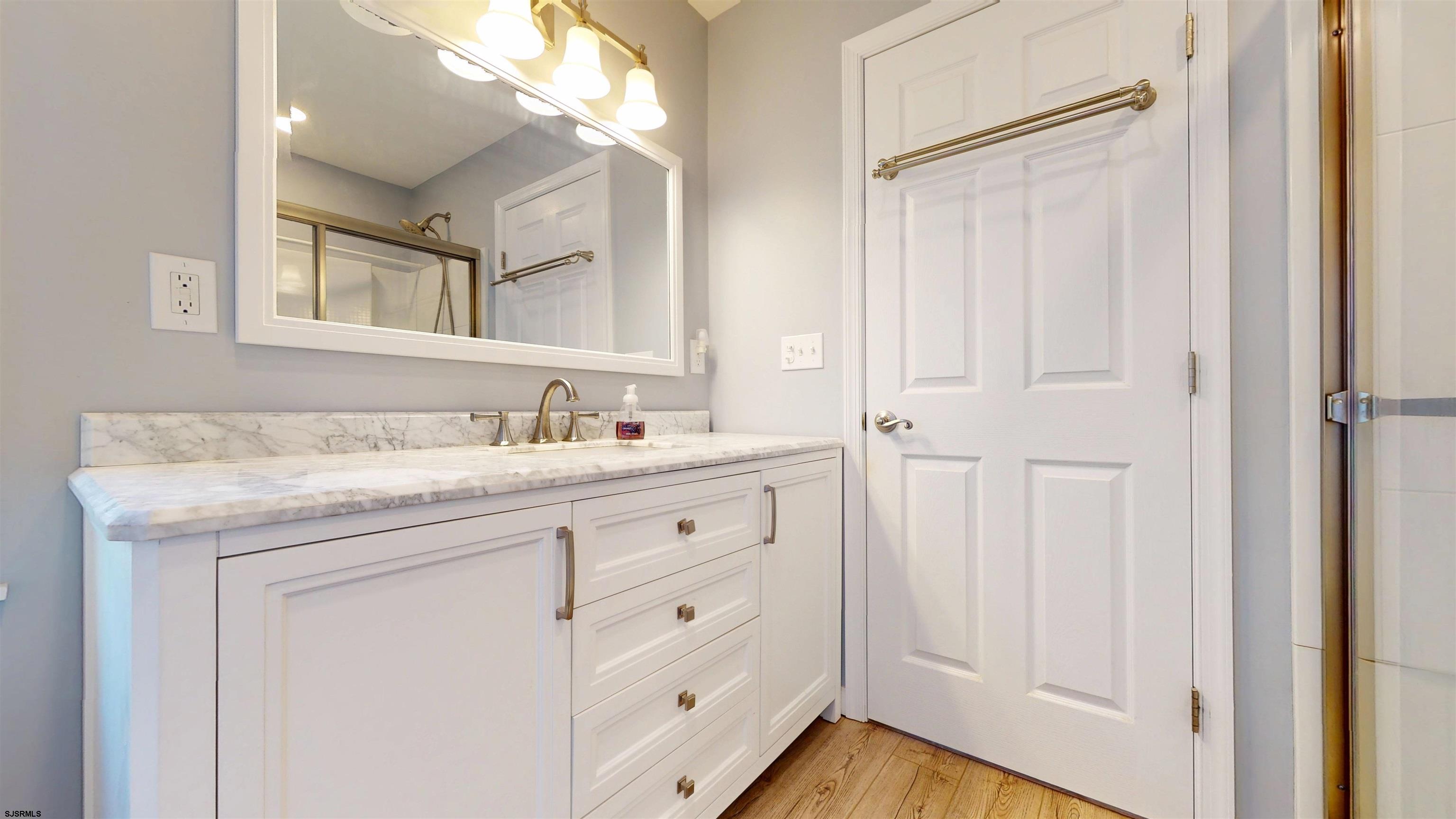46 Victoria Lane Ocean View, NJ 08230 - Photo 28 of 66 a bathroom with a granite countertop sink a mirror and a vanity