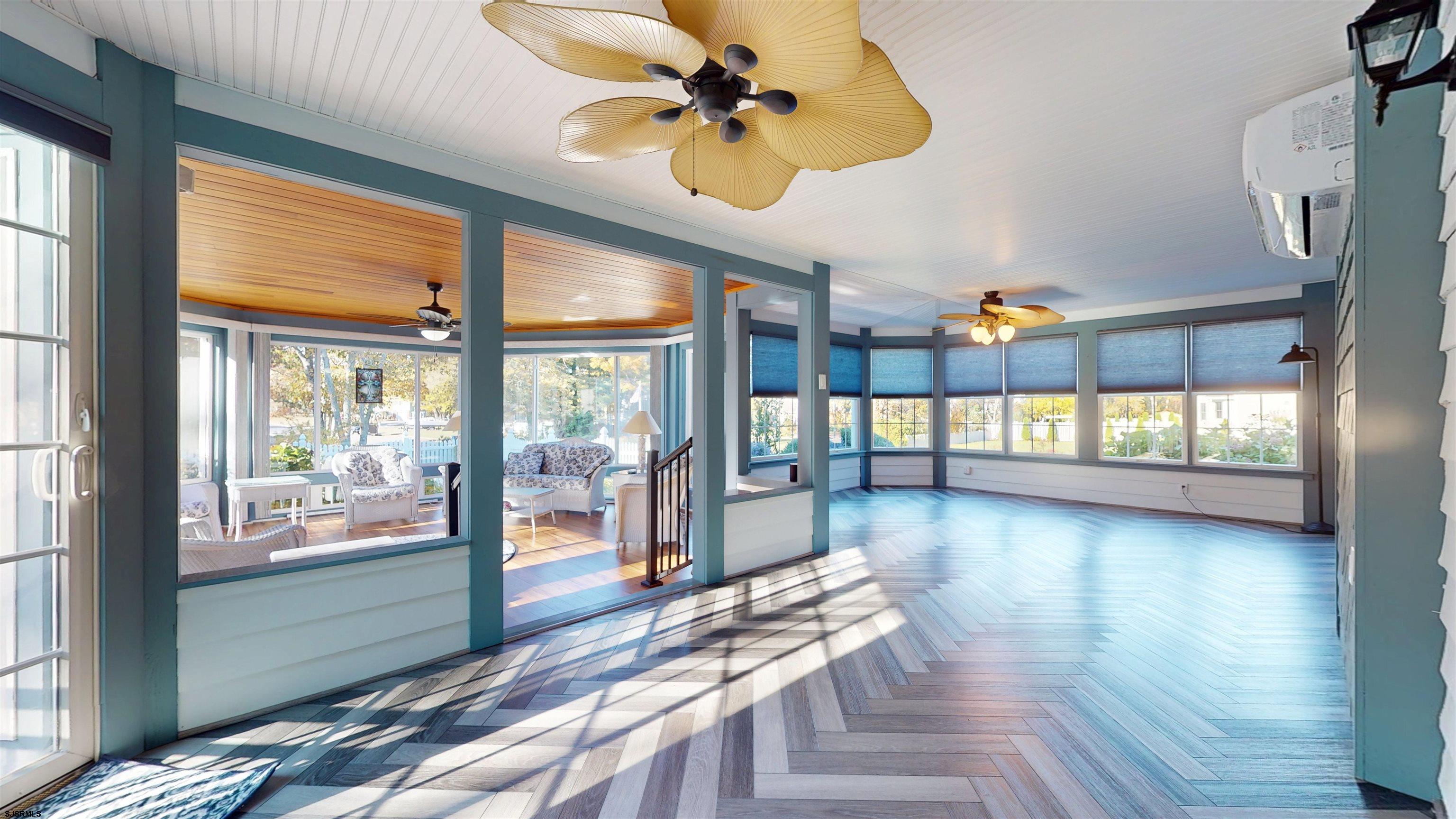 46 Victoria Lane Ocean View, NJ 08230 - Photo 41 of 66 a view of a livingroom with furniture wooden floor a ceiling fan and windows
