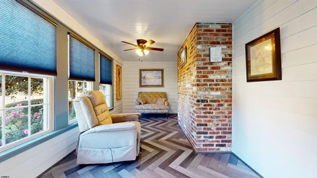an aerial view of a house with a yard and large trees