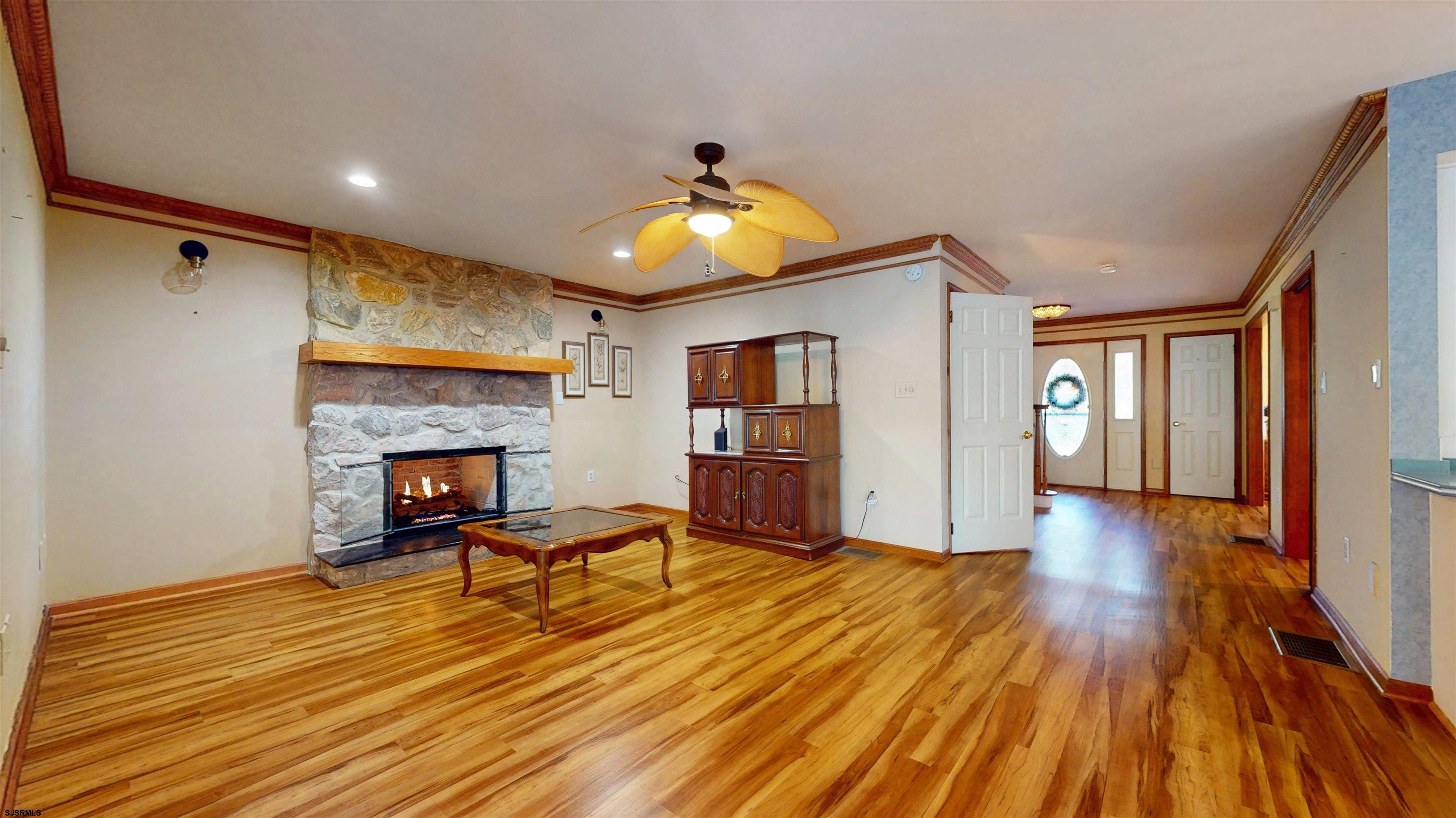 46 Victoria Lane Ocean View, NJ 08230 - Photo 8 of 66 a view of a livingroom with wooden floor and a fireplace