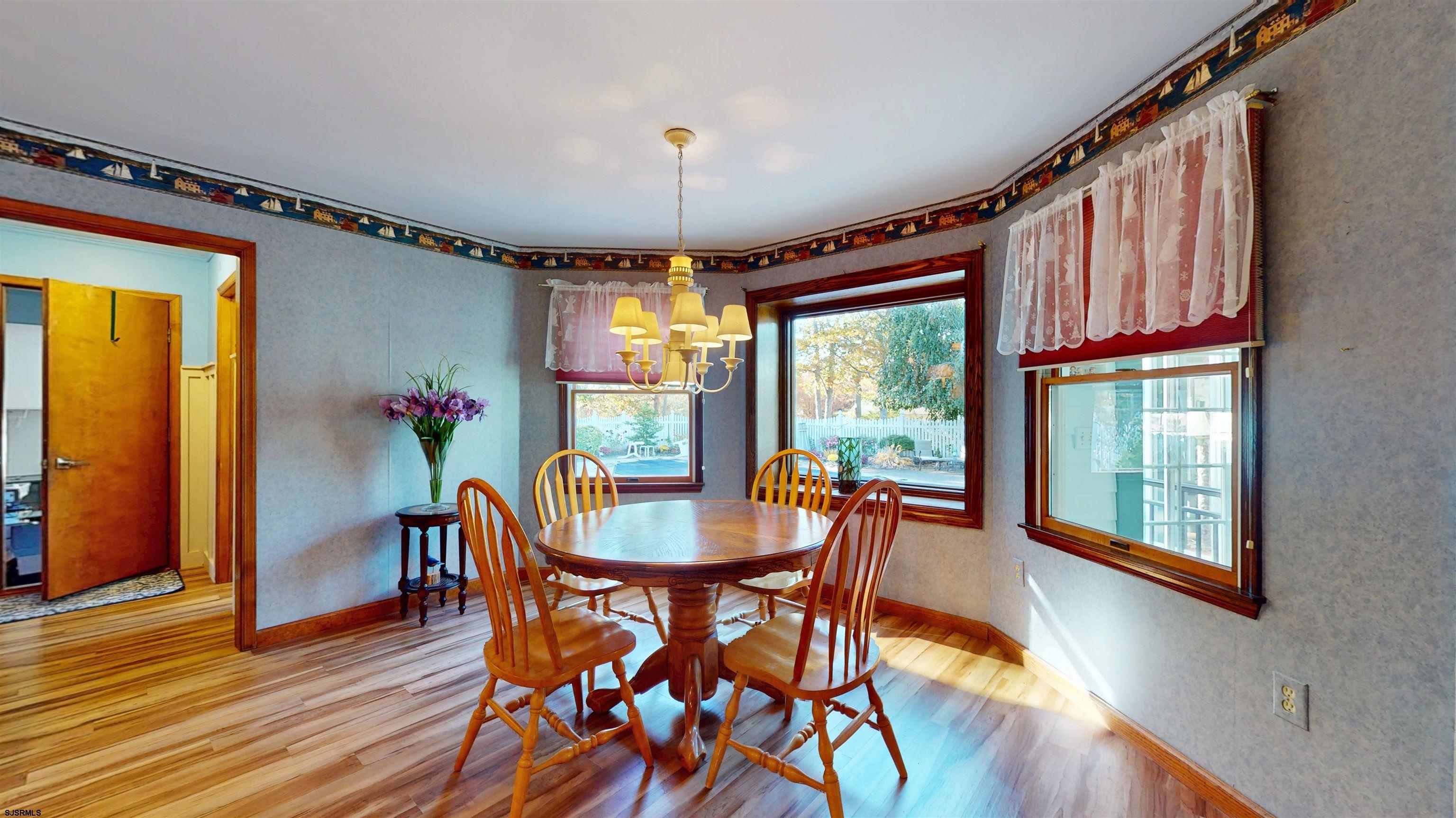 46 Victoria Lane Ocean View, NJ 08230 - Photo 10 of 66 a dining room with furniture a chandelier and wooden floor