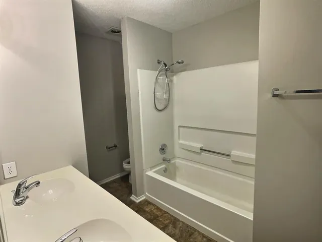 a bathroom with a bathtub and a shower