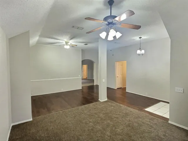 an empty room with fan and fan
