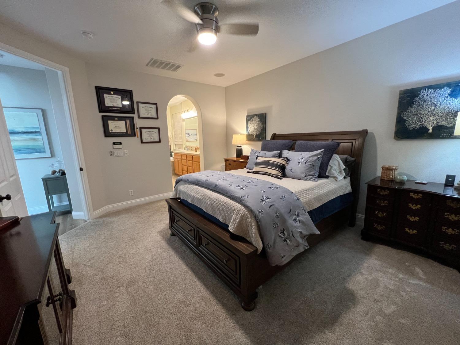 1135 North Perry Avenue Clovis, CA 93611 - Photo 14 of 27 a bedroom with a bed and a chandelier