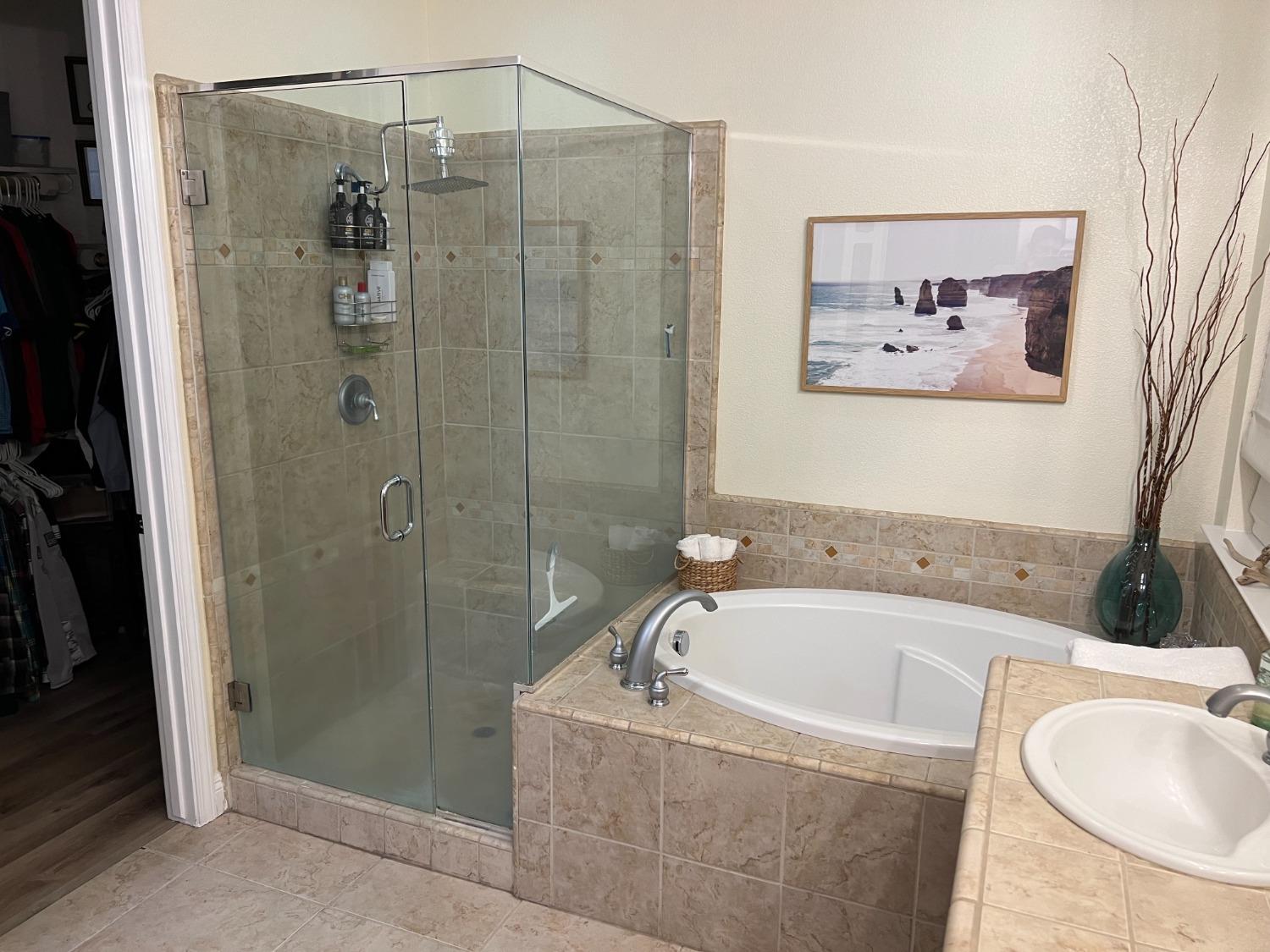 1135 North Perry Avenue Clovis, CA 93611 - Photo 17 of 27 a bathroom with a tub a sink and glass door shower