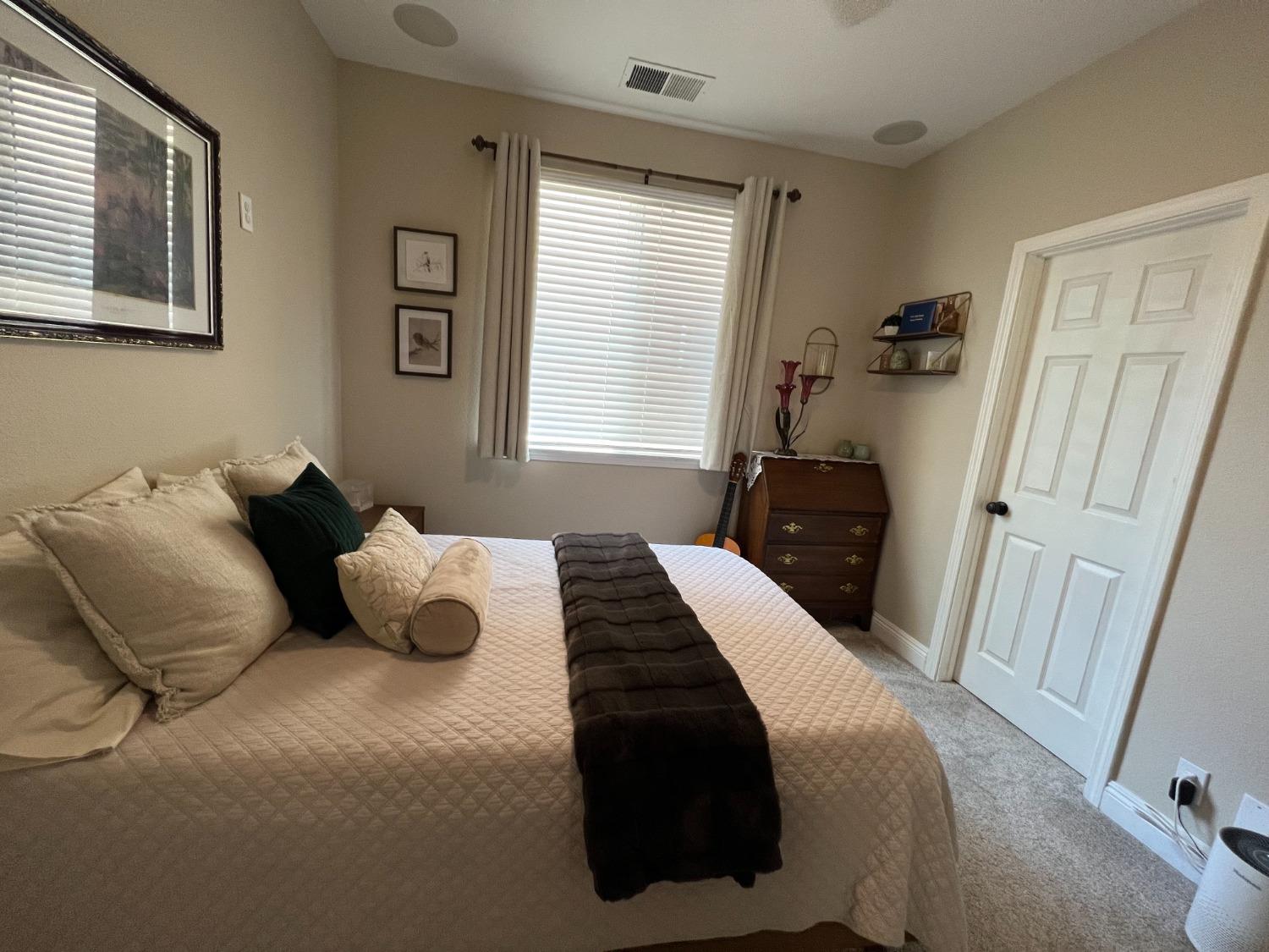 1135 North Perry Avenue Clovis, CA 93611 - Photo 18 of 27 a bedroom with a bed and window