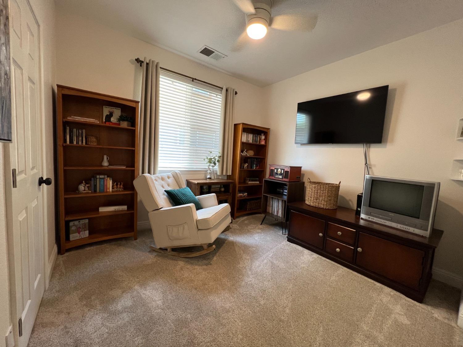 1135 North Perry Avenue Clovis, CA 93611 - Photo 21 of 27 a living room with furniture and a flat screen tv