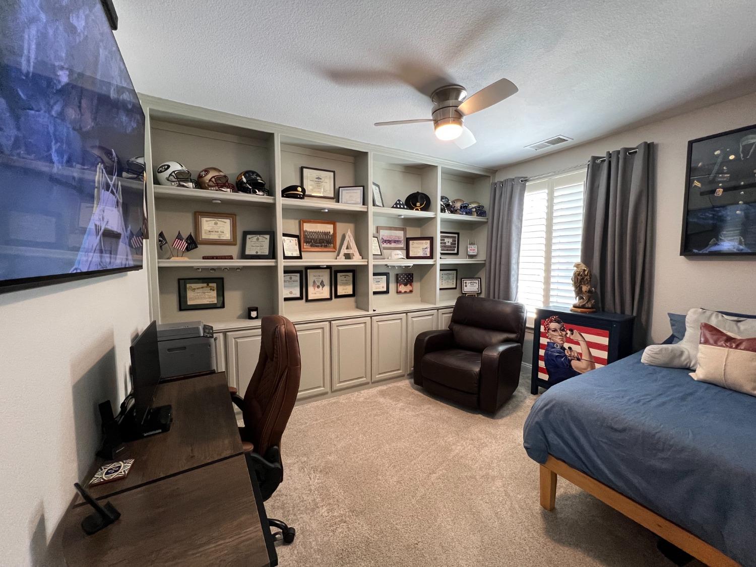 1135 North Perry Avenue Clovis, CA 93611 - Photo 22 of 27 a bedroom with furniture and a book shelf