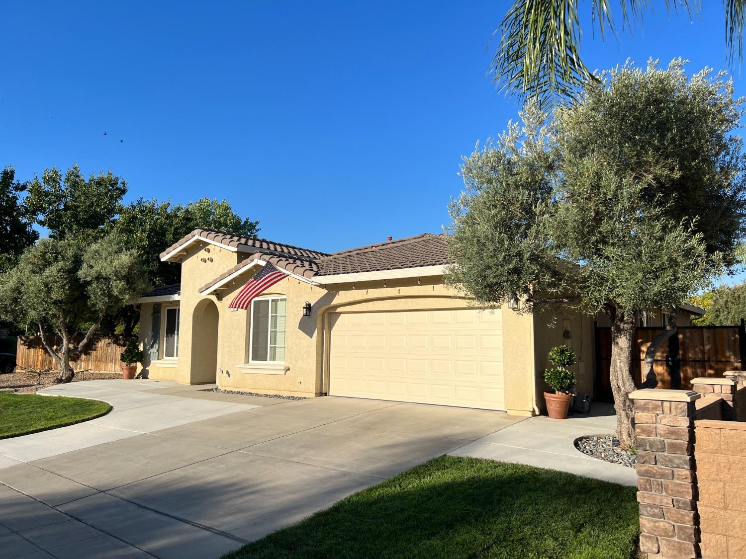 1135 North Perry Avenue Clovis, CA 93611 - Photo 3 of 27 a front view of a house with a yard and garage