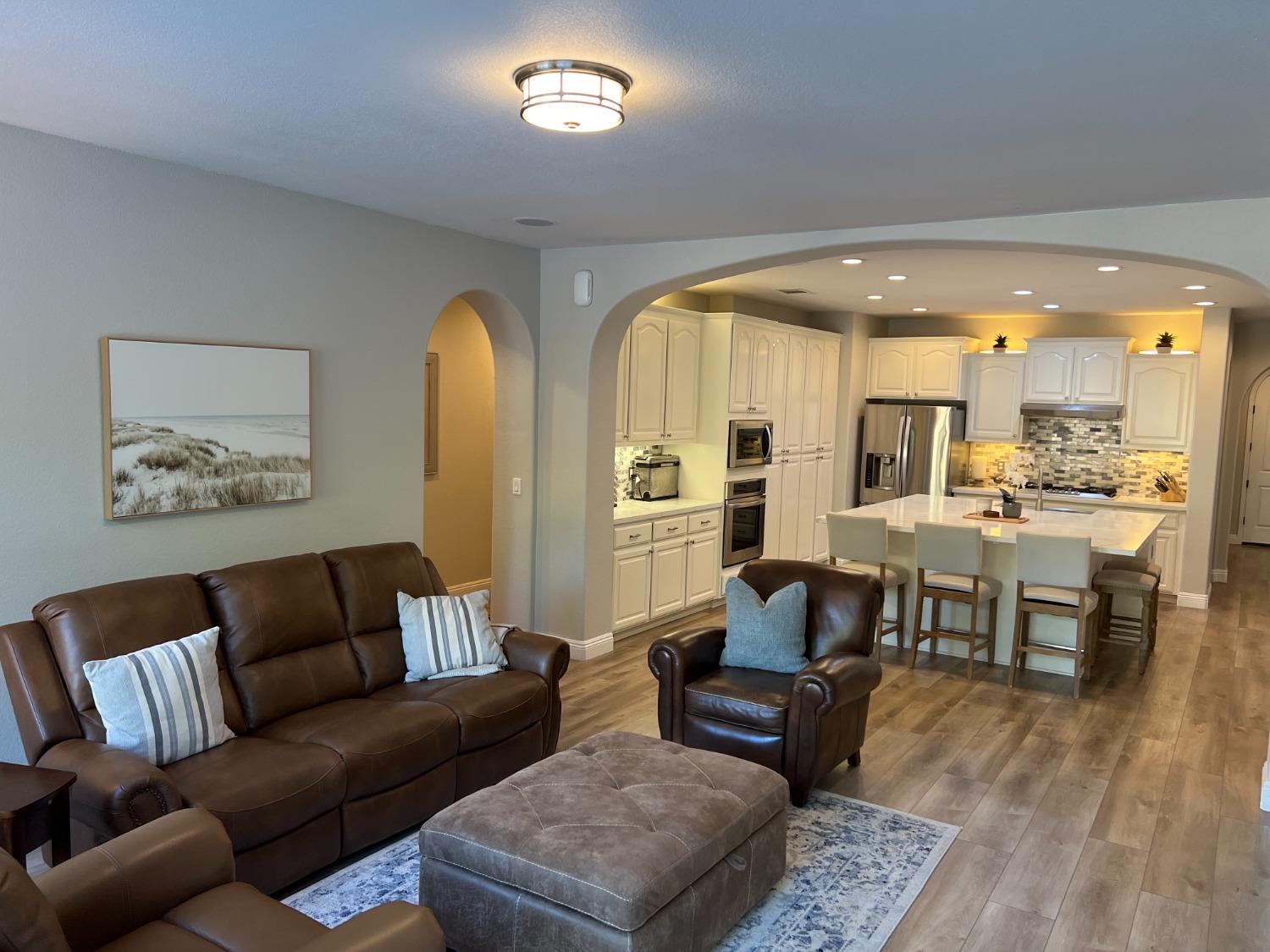 1135 North Perry Avenue Clovis, CA 93611 - Photo 7 of 27 a living room with furniture kitchen view and a wooden floor