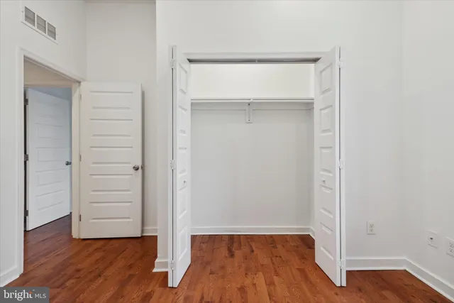an empty room with wooden floor