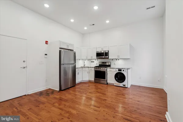 a kitchen with stainless steel appliances a refrigerator sink and stove
