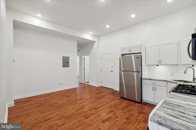 a kitchen with a refrigerator and a sink