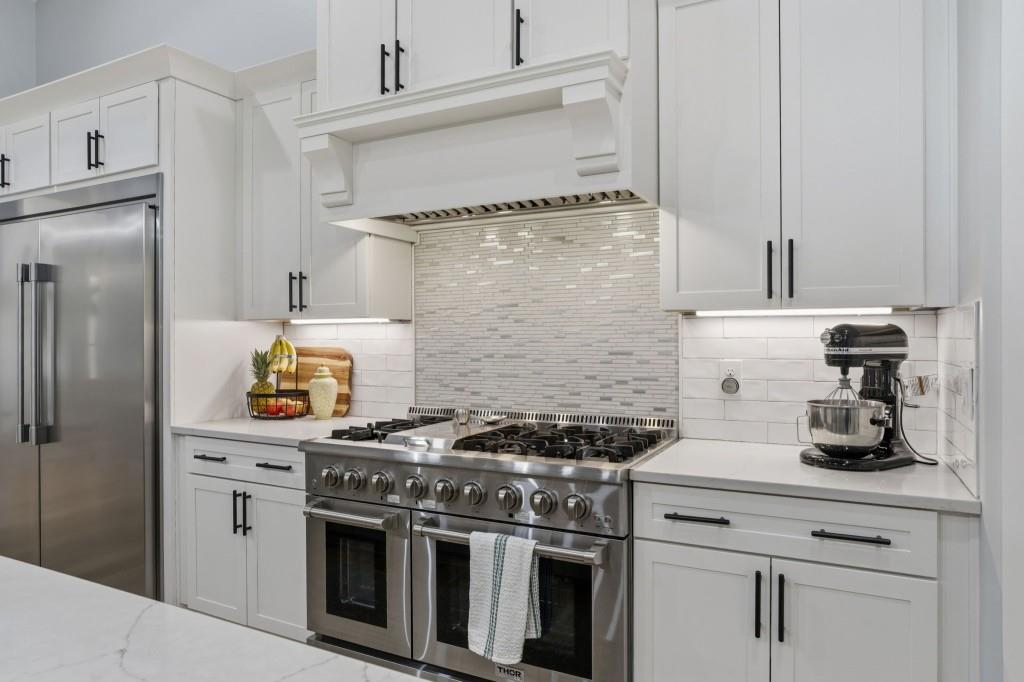 1416 Mt Bethel Road McDonough, GA 30252 - Photo 22 of 67 a kitchen with stainless steel appliances granite countertop a stove and a refrigerator
