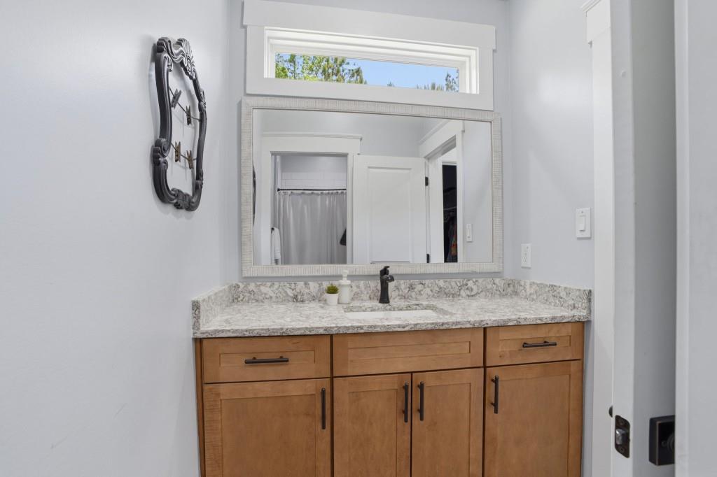 1416 Mt Bethel Road McDonough, GA 30252 - Photo 48 of 67 a bathroom with a granite countertop sink and a mirror