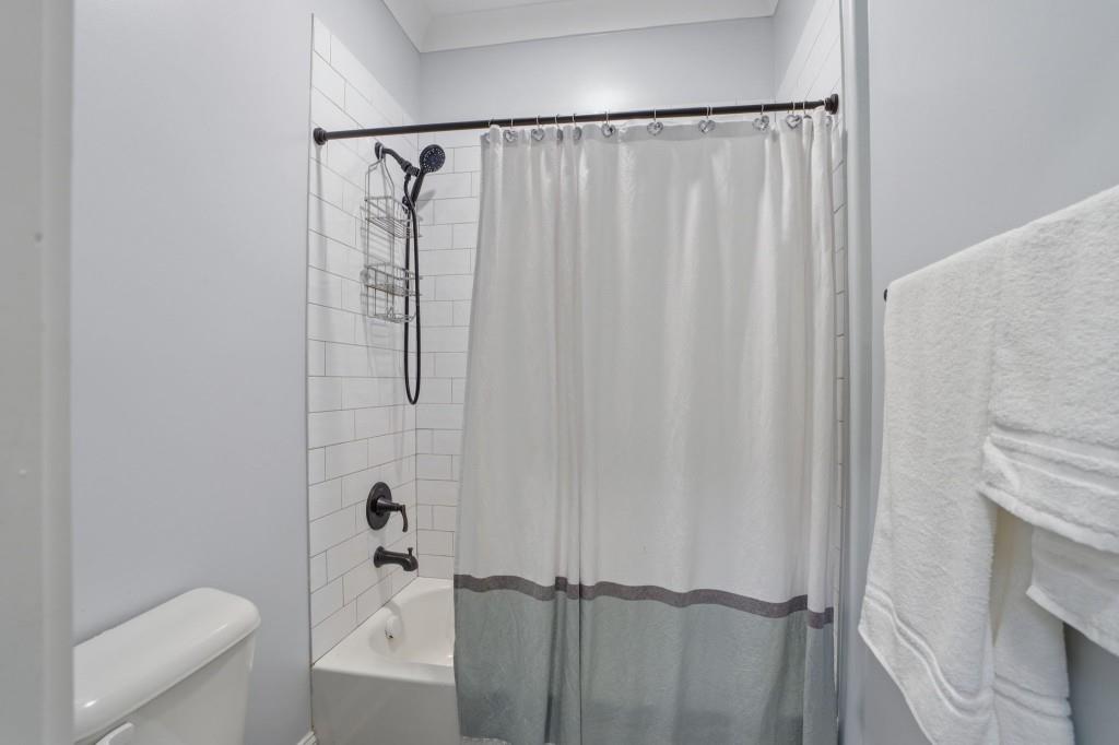 1416 Mt Bethel Road McDonough, GA 30252 - Photo 49 of 67 a bathroom with a shower curtain and a toilet