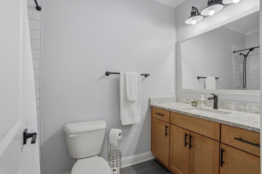 1416 Mt Bethel Road McDonough, GA 30252 - Photo 51 of 67 a bathroom with a toilet sink vanity granite and mirror