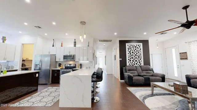 a living room with kitchen island furniture and a wooden floor